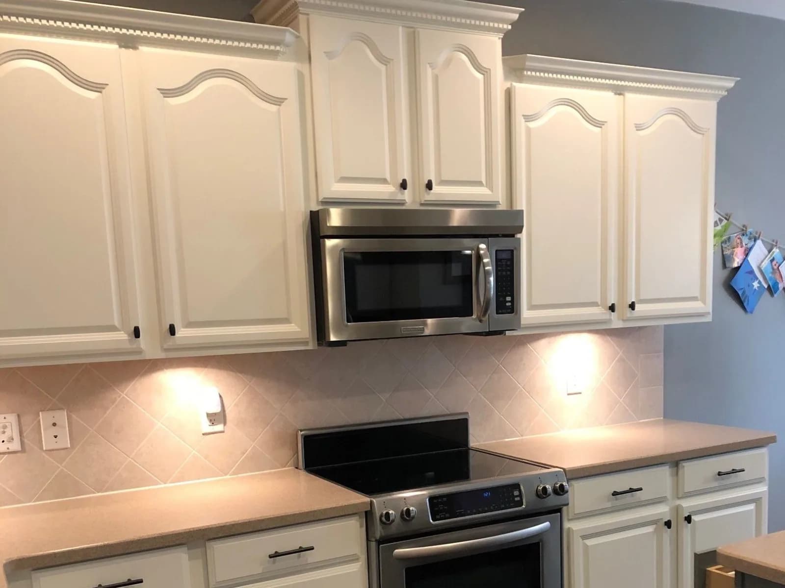 Arched oak cabinets painted white