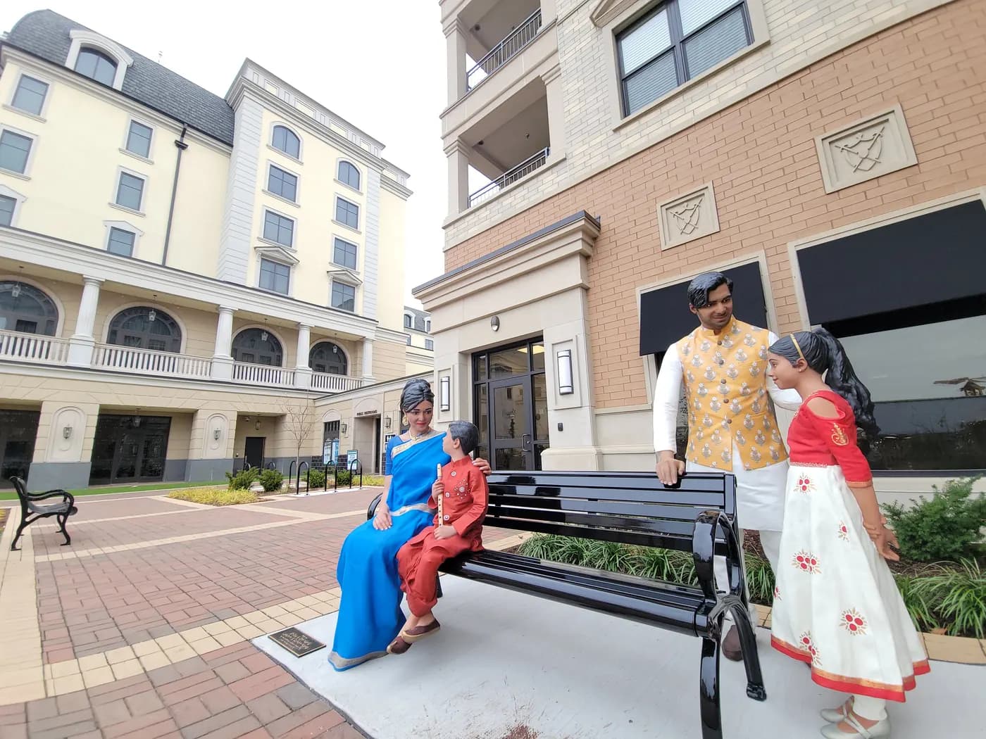 Indian Heritage, a lifelike public sculpture of a family of four gathered around a bench in Carmel
