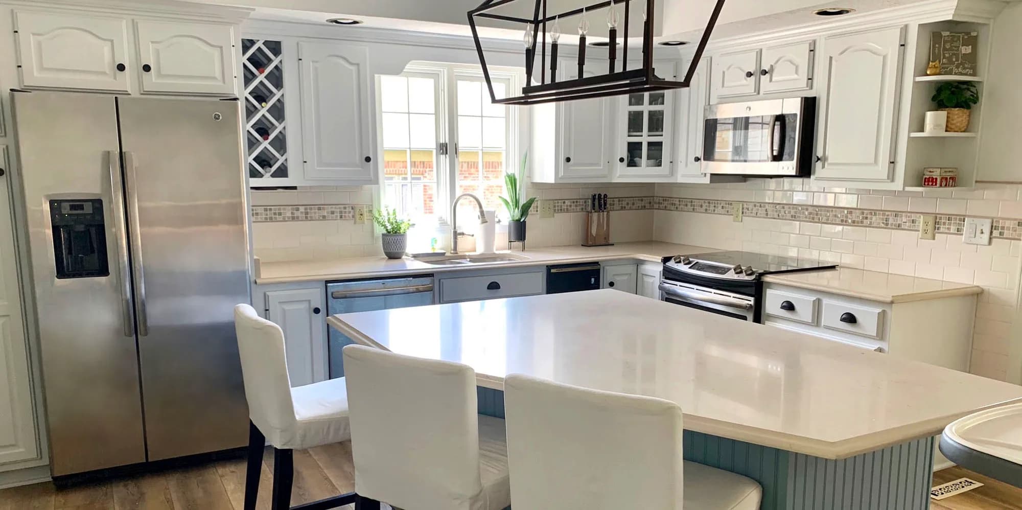 After: Cherry kitchen cabinets painted white, island included