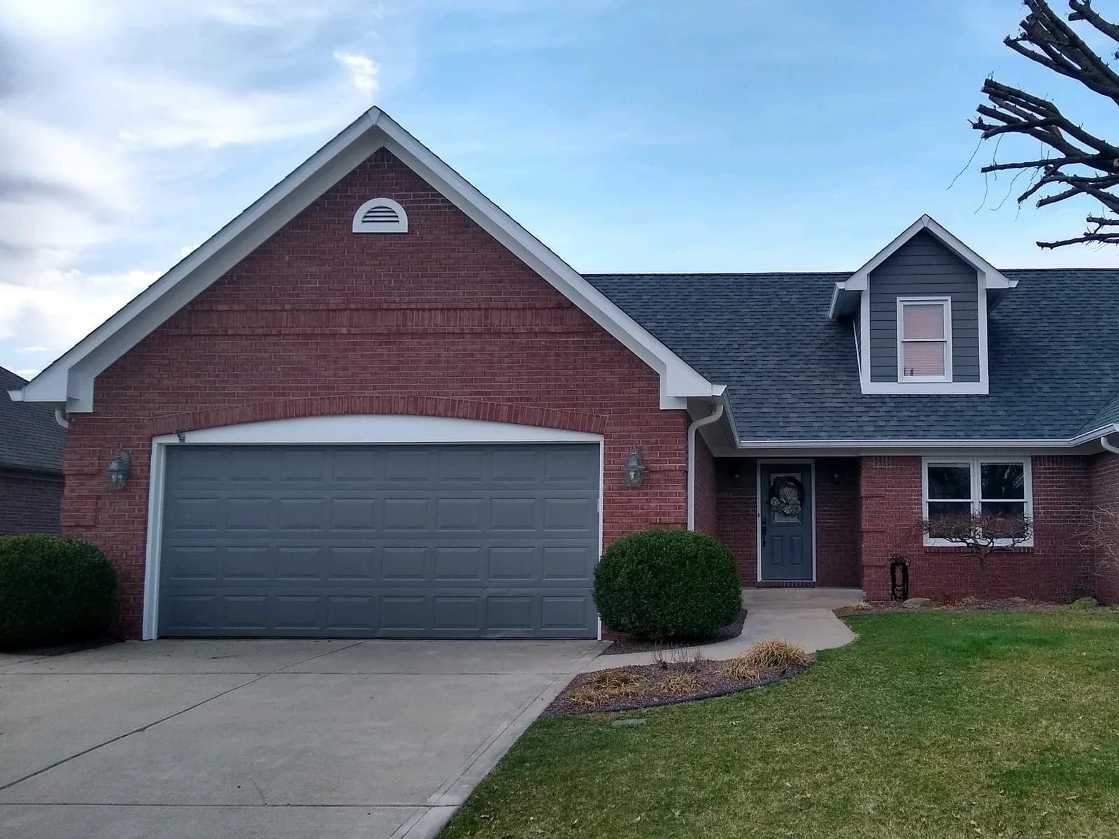 Garage door and trim repainted on a brick ranch